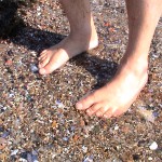 Ken Bob's feet in clam shells on beach