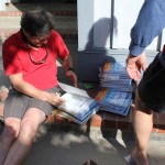 Roy autographing books for delivery
